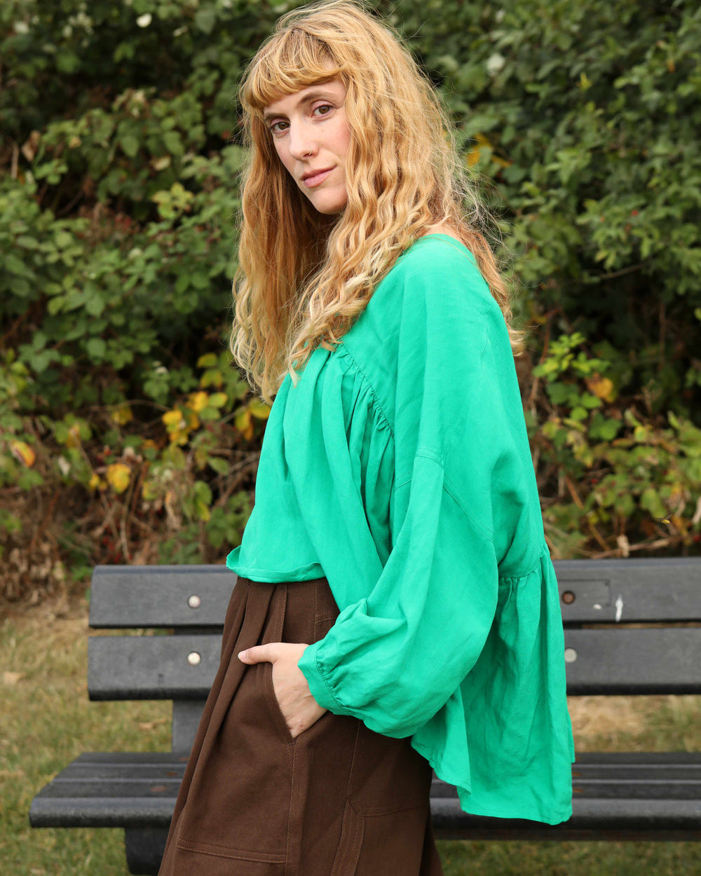 A vibrant grass green, voluminous statement top with a V-neckline and 3/4 length sleeves.