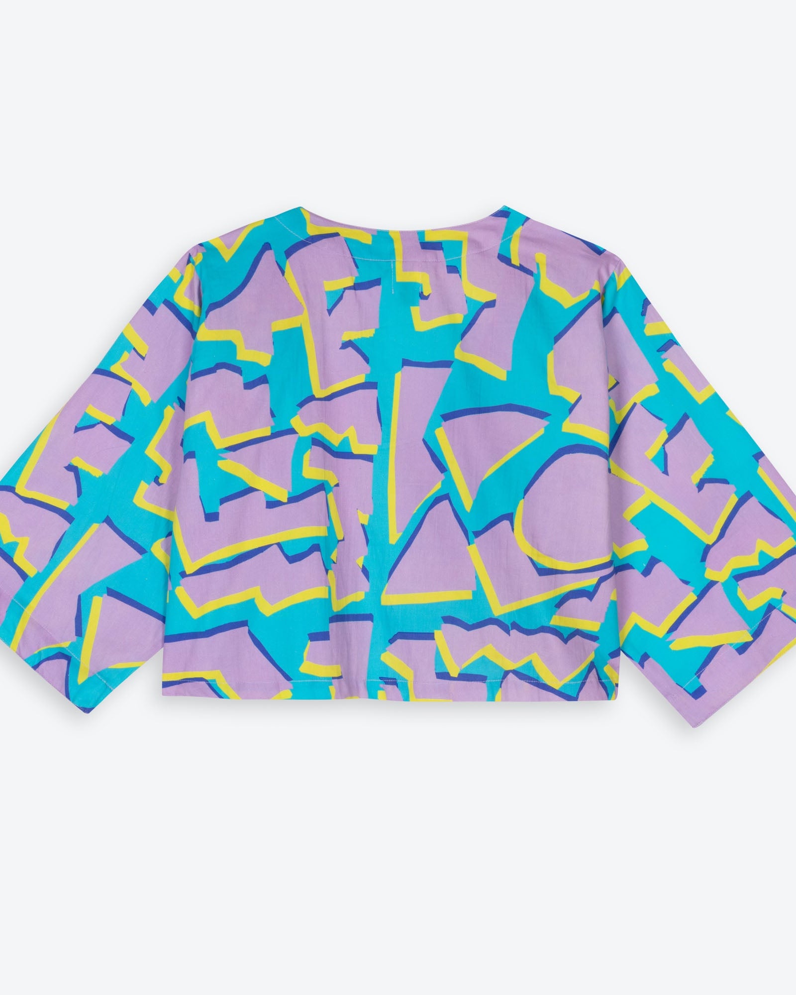 Colorful geometric patterned shirt on a white background