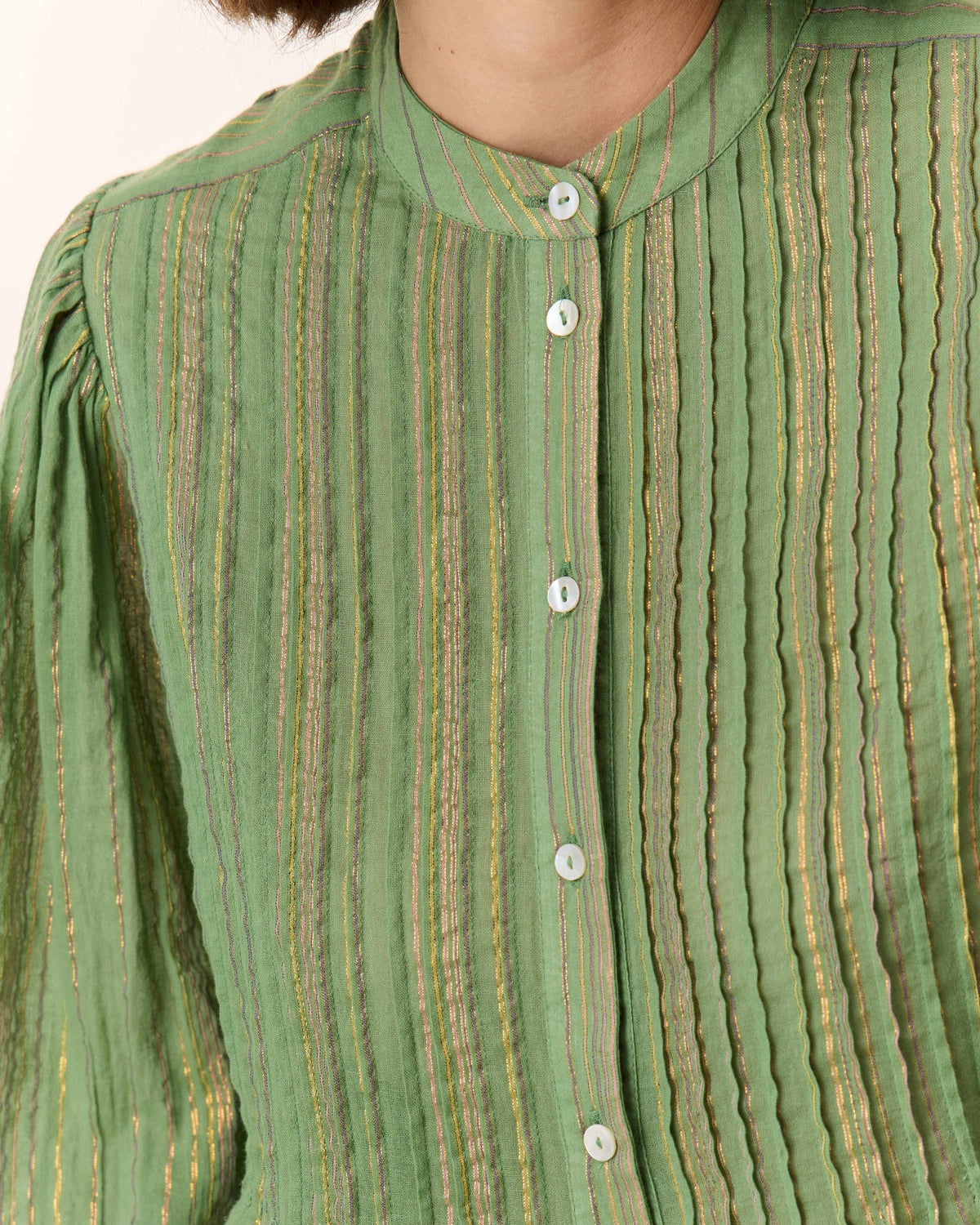 Close-up of a green striped shirt with buttons