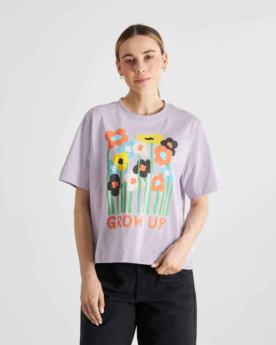 A relaxed fit purple T-shirt with a graphic of flowers and the text 'GROW UP' designed by Luke John Arnold.