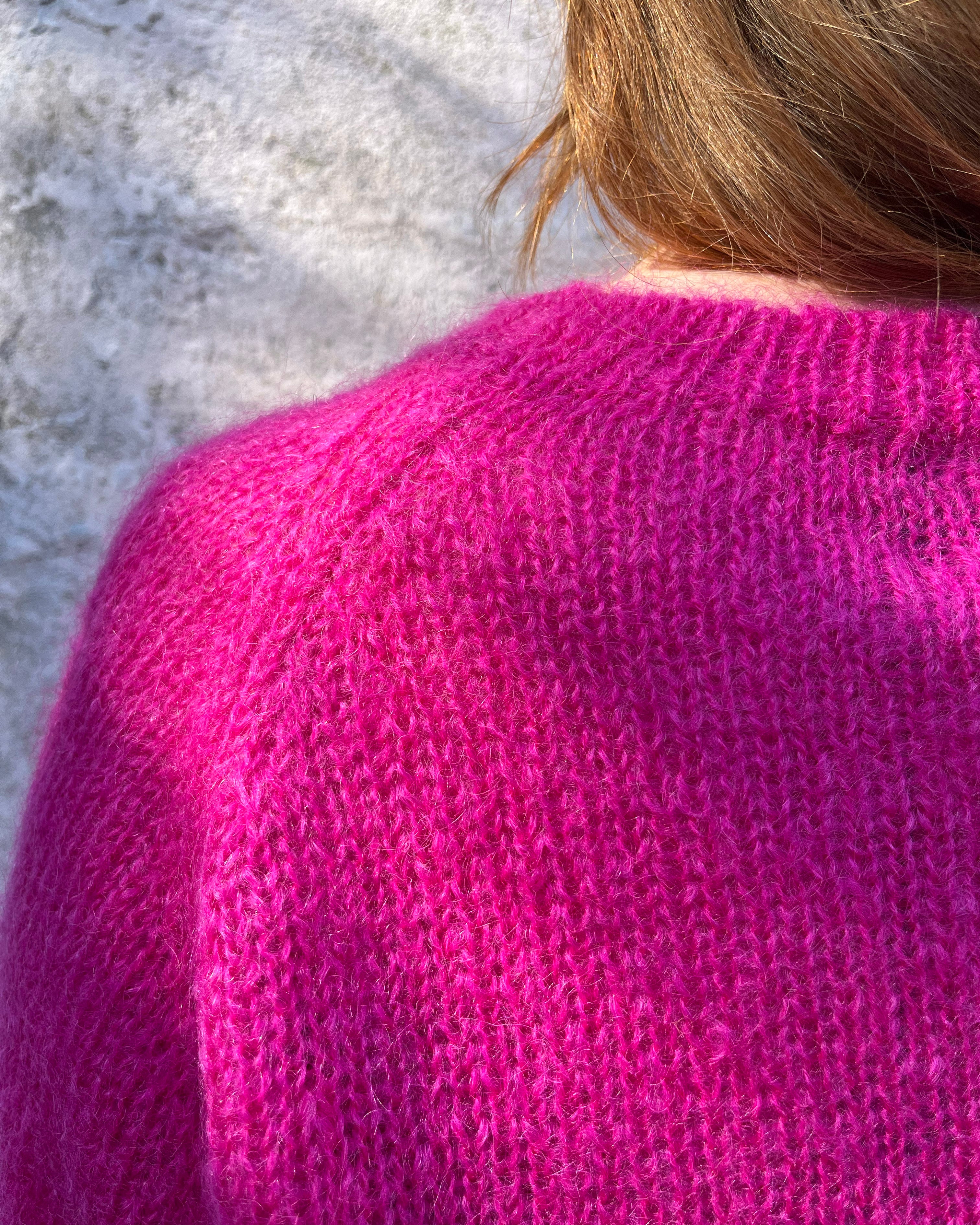 Person wearing bright pink mohair jumper