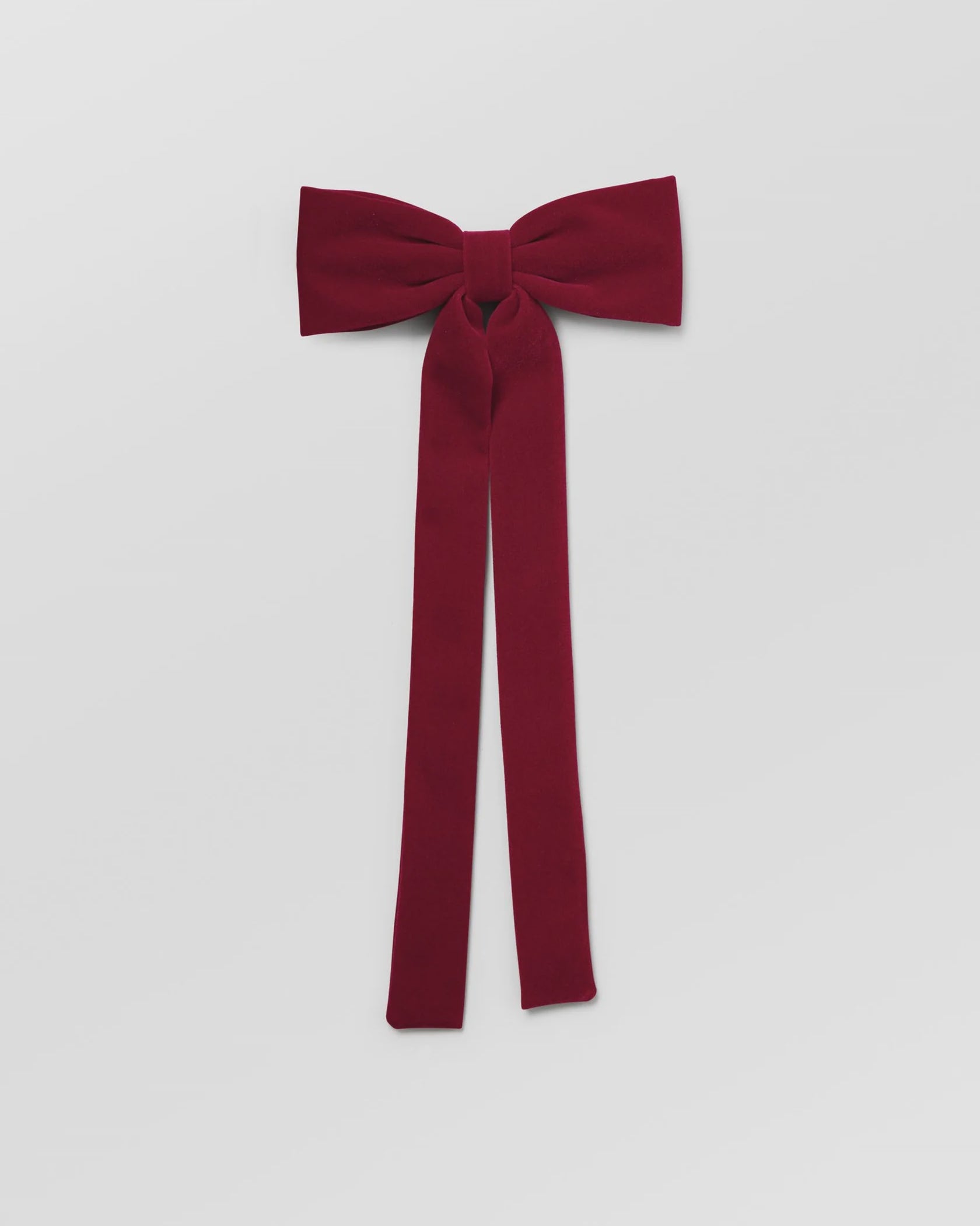 Red bow tie on a light gray background