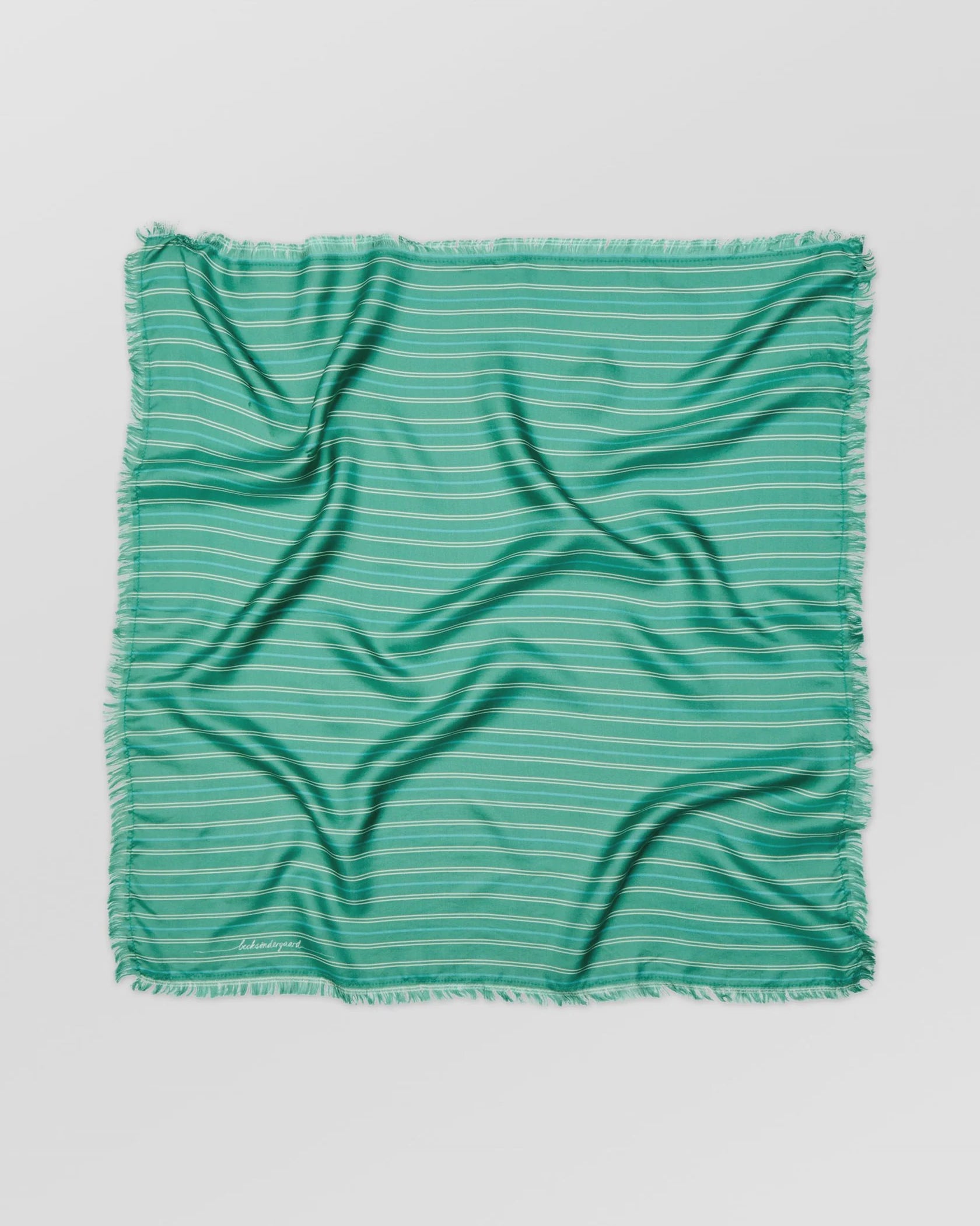 Green striped fabric on a light gray background