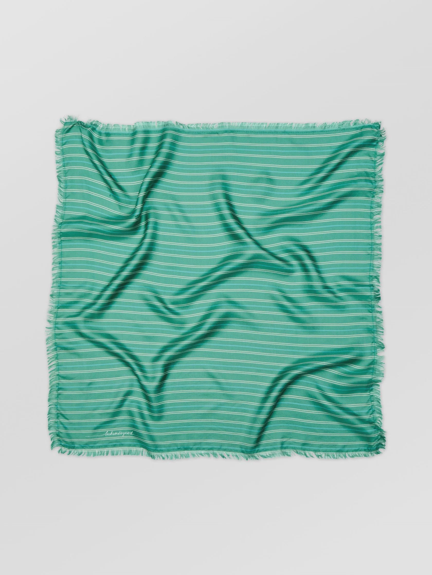 Green striped fabric on a light gray background