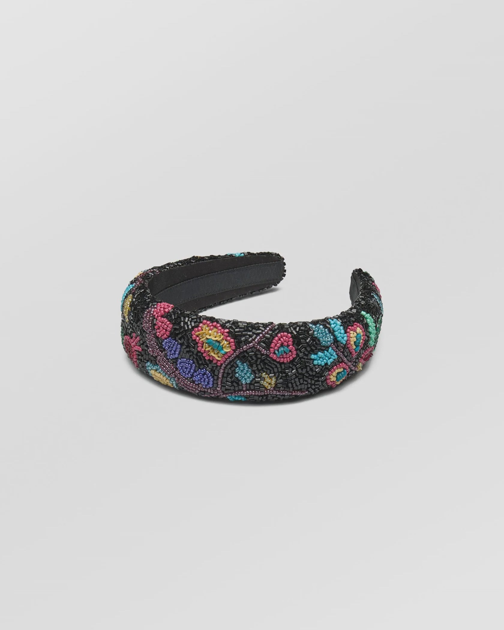 Decorative headband with colorful floral pattern on a light gray background