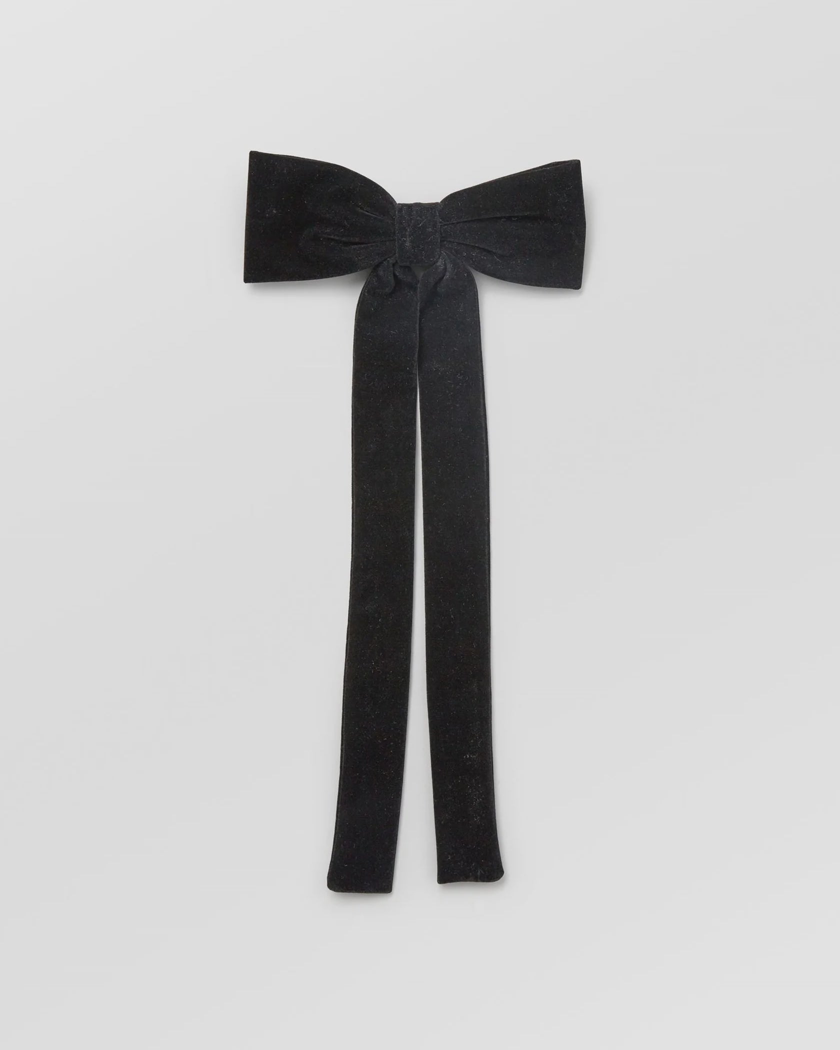 Black bow tie on a light gray background