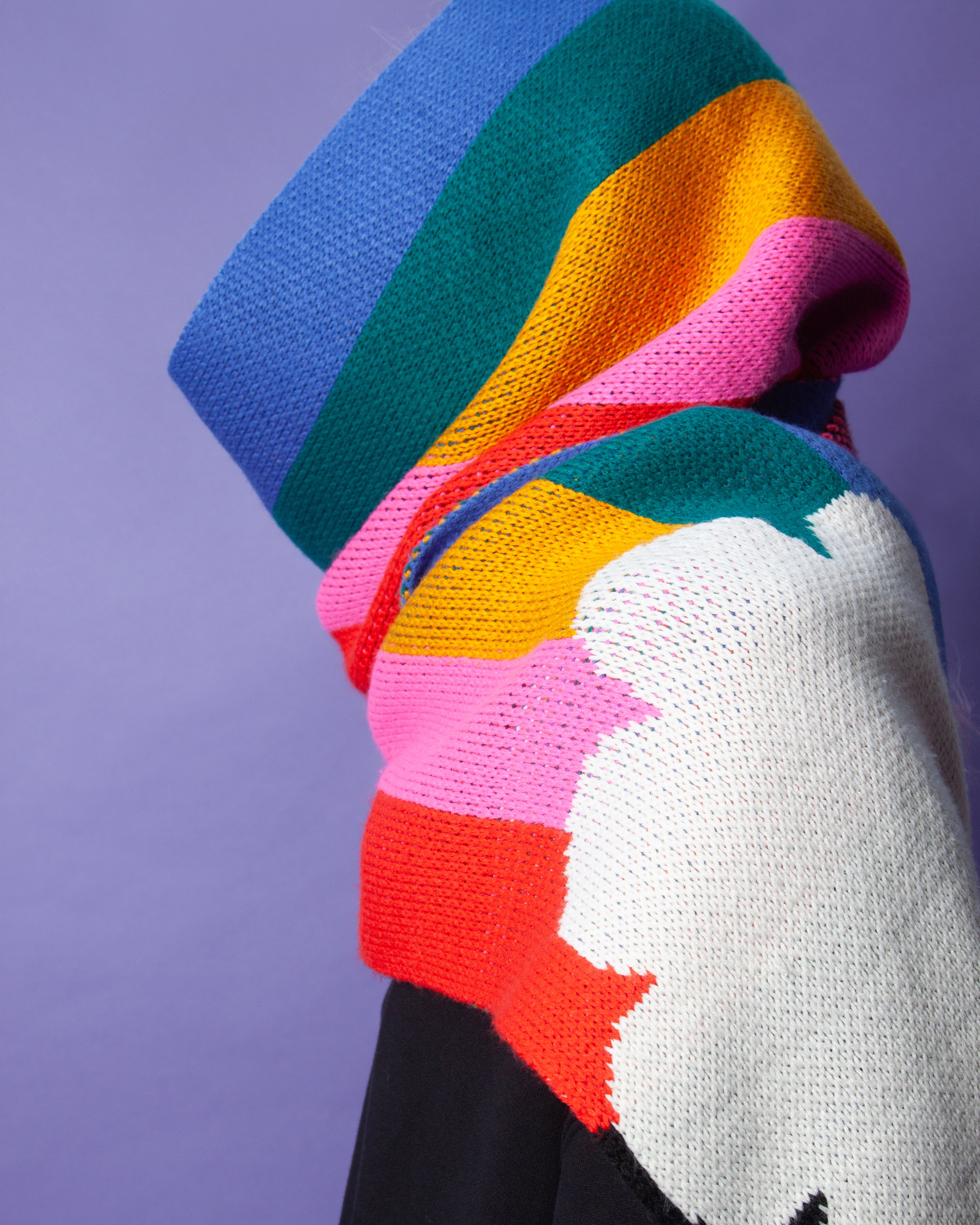 Person wearing a rainbow scarf