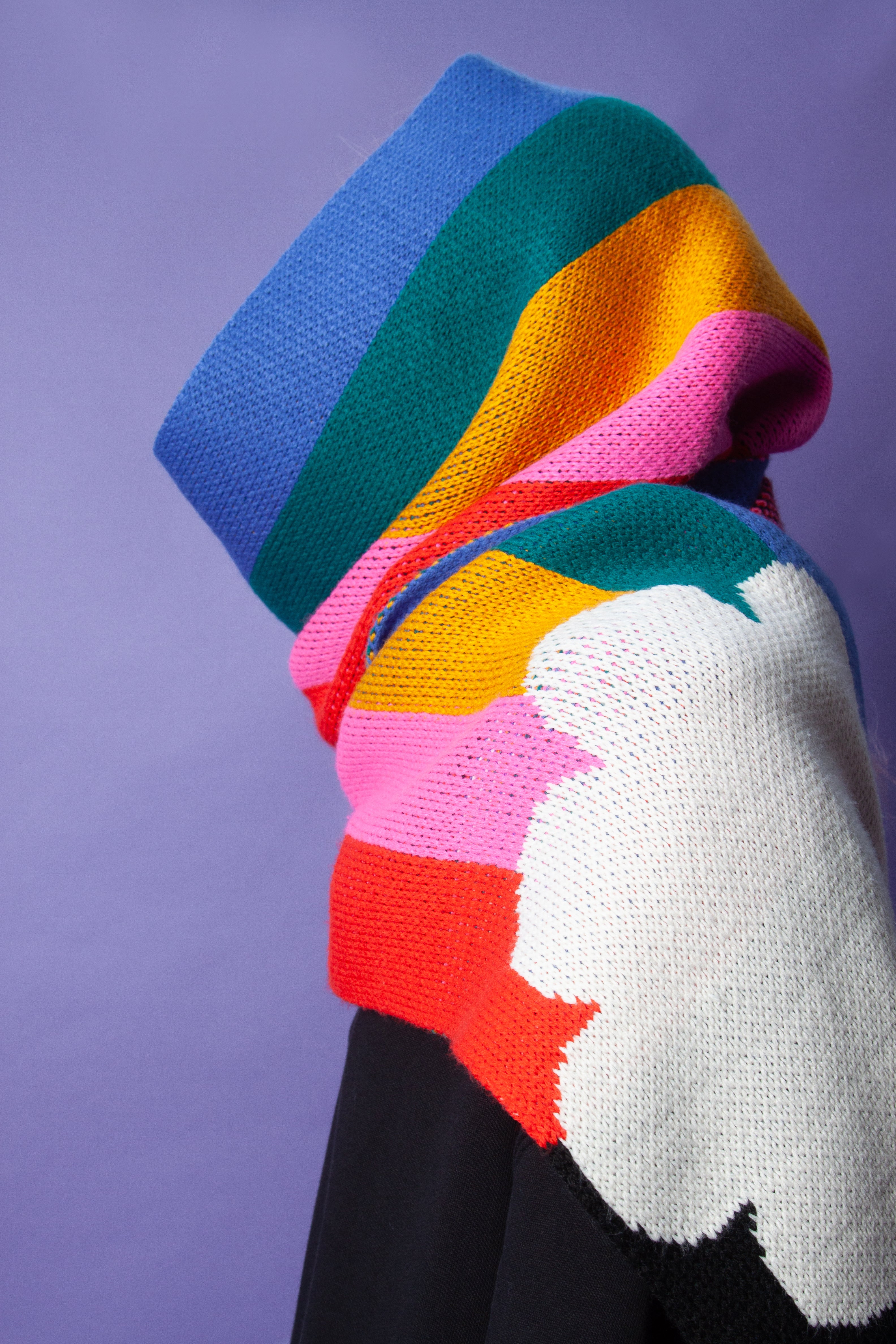 Person wearing a rainbow scarf