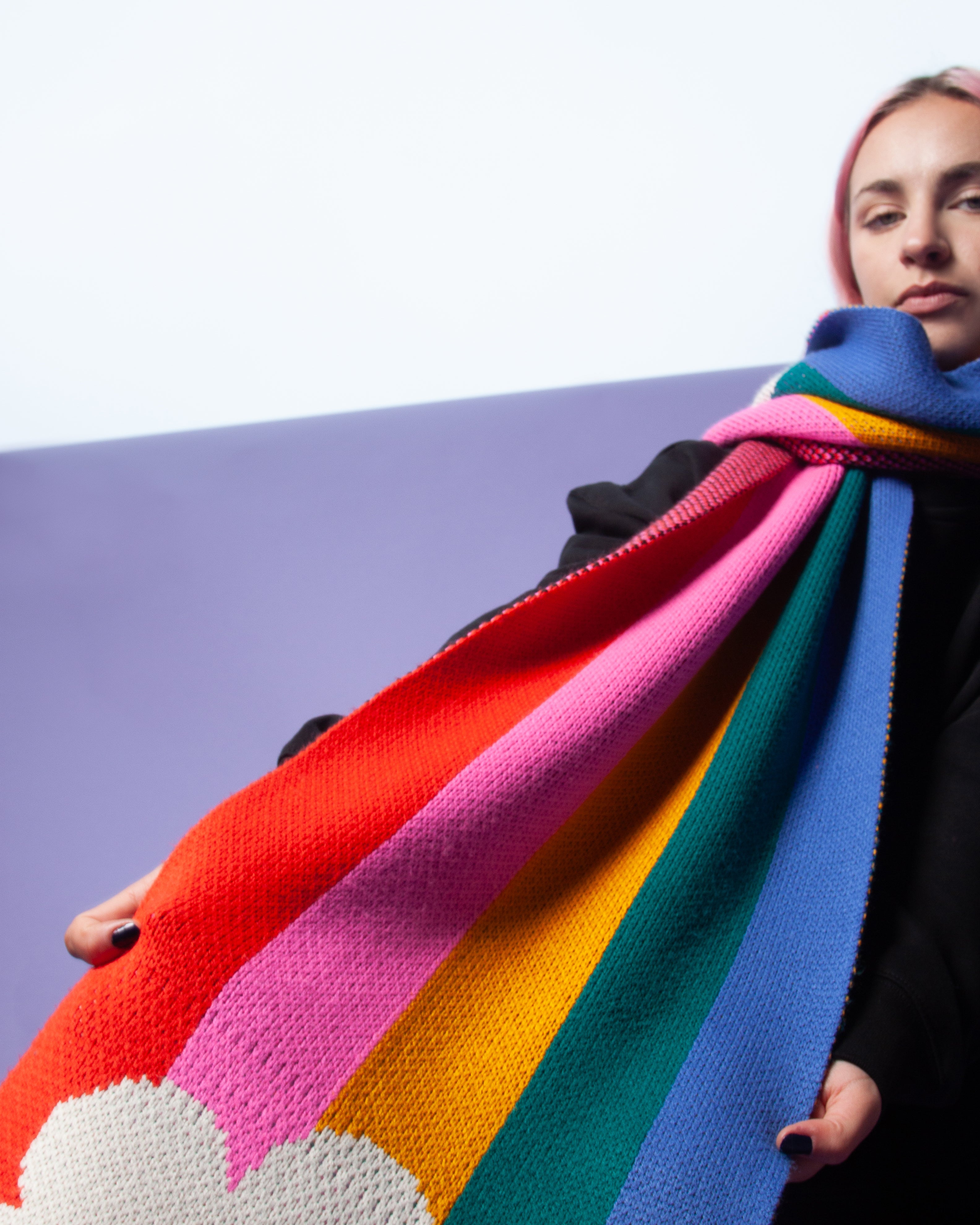 Person wearing a rainbow scarf