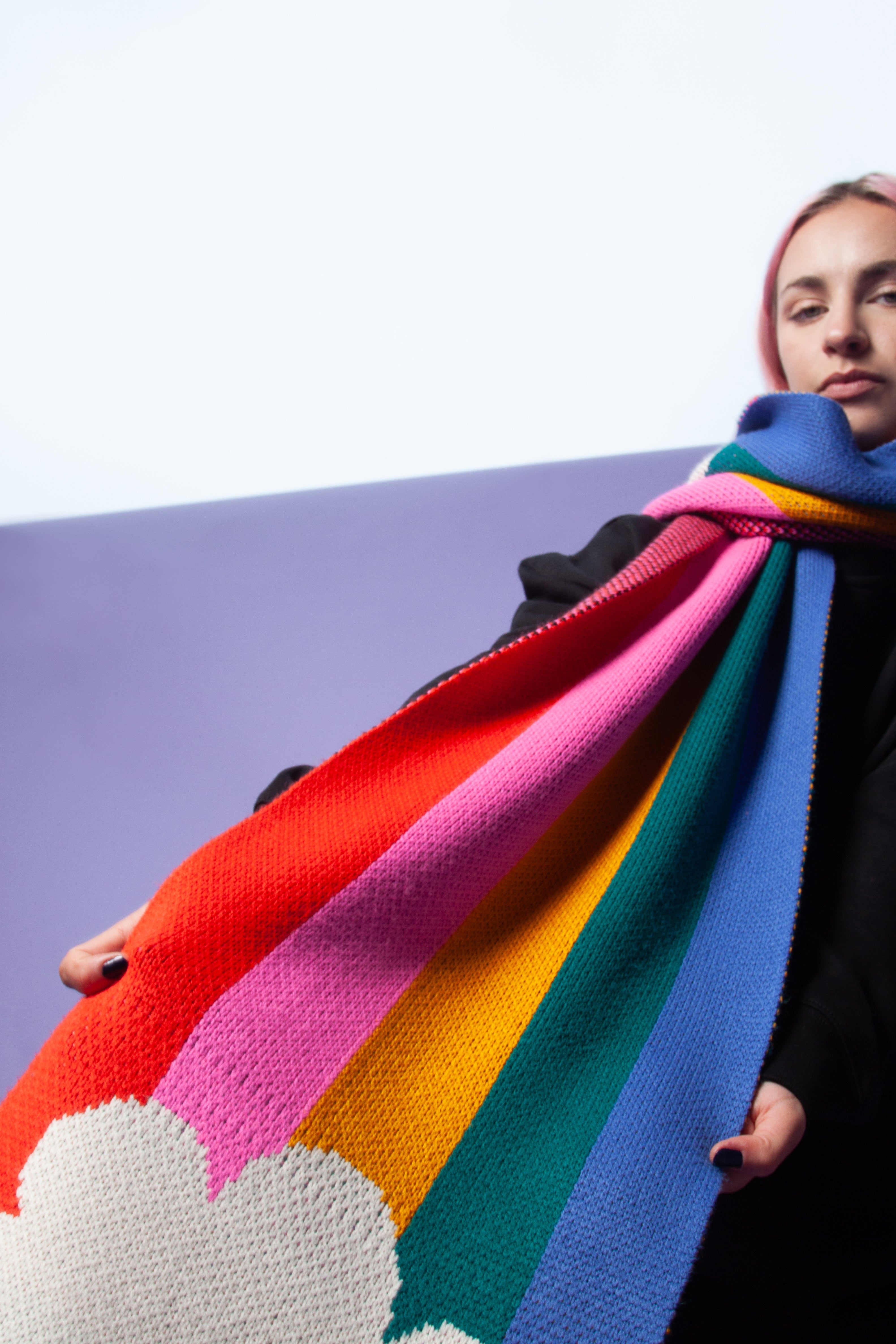 Person wearing a rainbow scarf