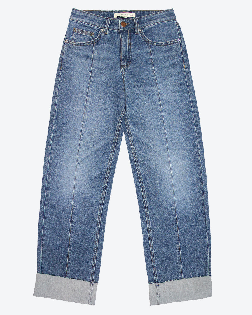 A pair of blue denim jeans with a deep frayed turn up at the hem, featuring a straight leg cut and mid-rise waist.