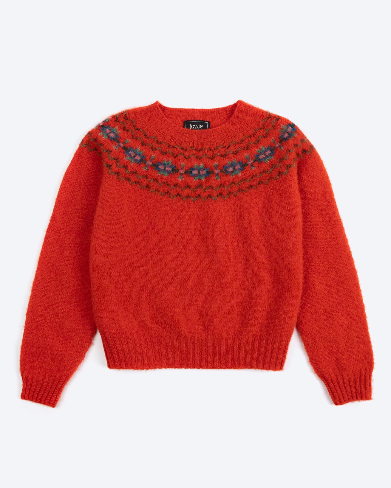 Red sweater with patterned neckline on a white background