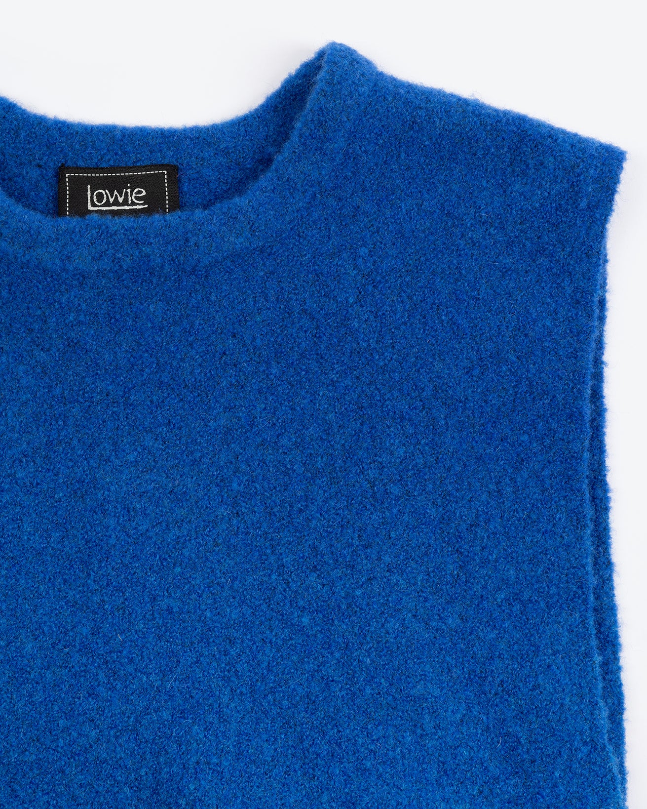 A cobalt blue sleeveless vest with a round neckline and adjustable side ties.