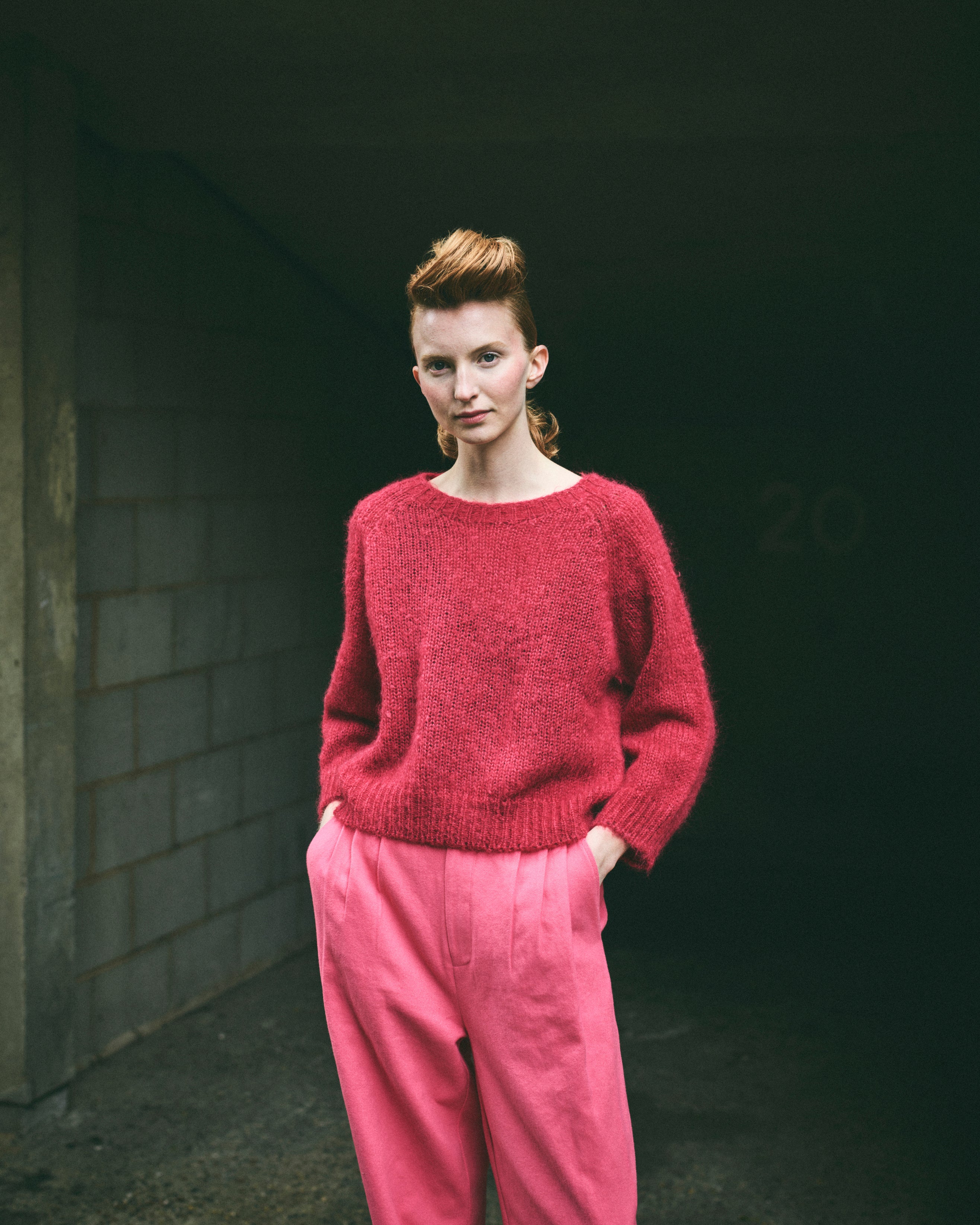 A cropped, bracelet sleeve, round neck red mohair jumper.