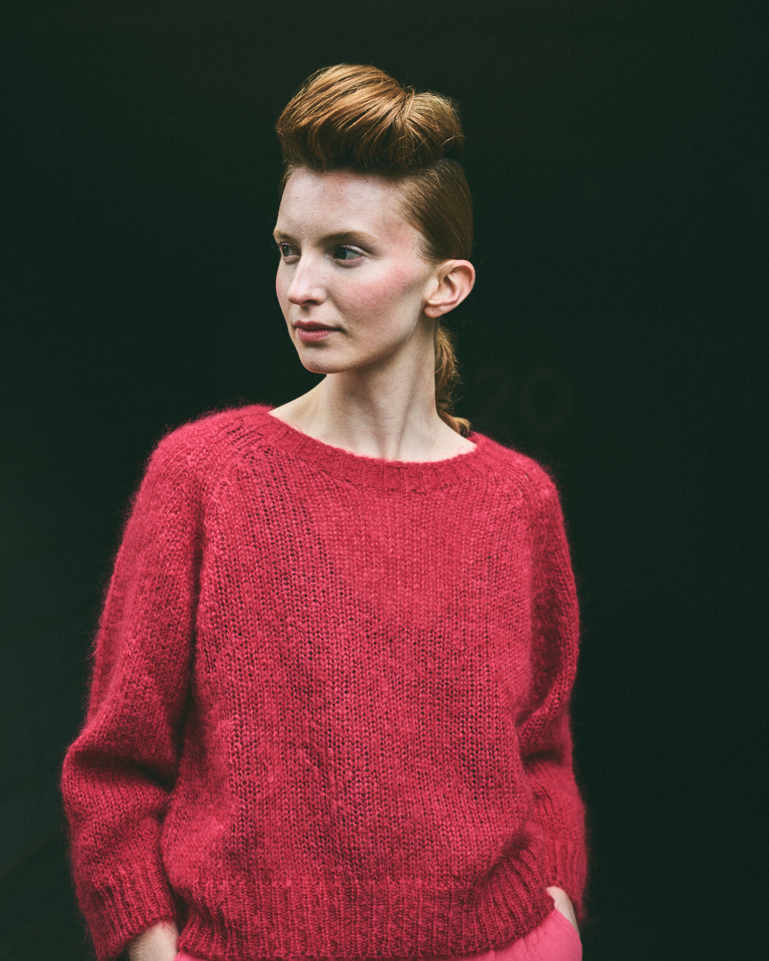 A cropped, bracelet sleeve, round neck red mohair jumper.