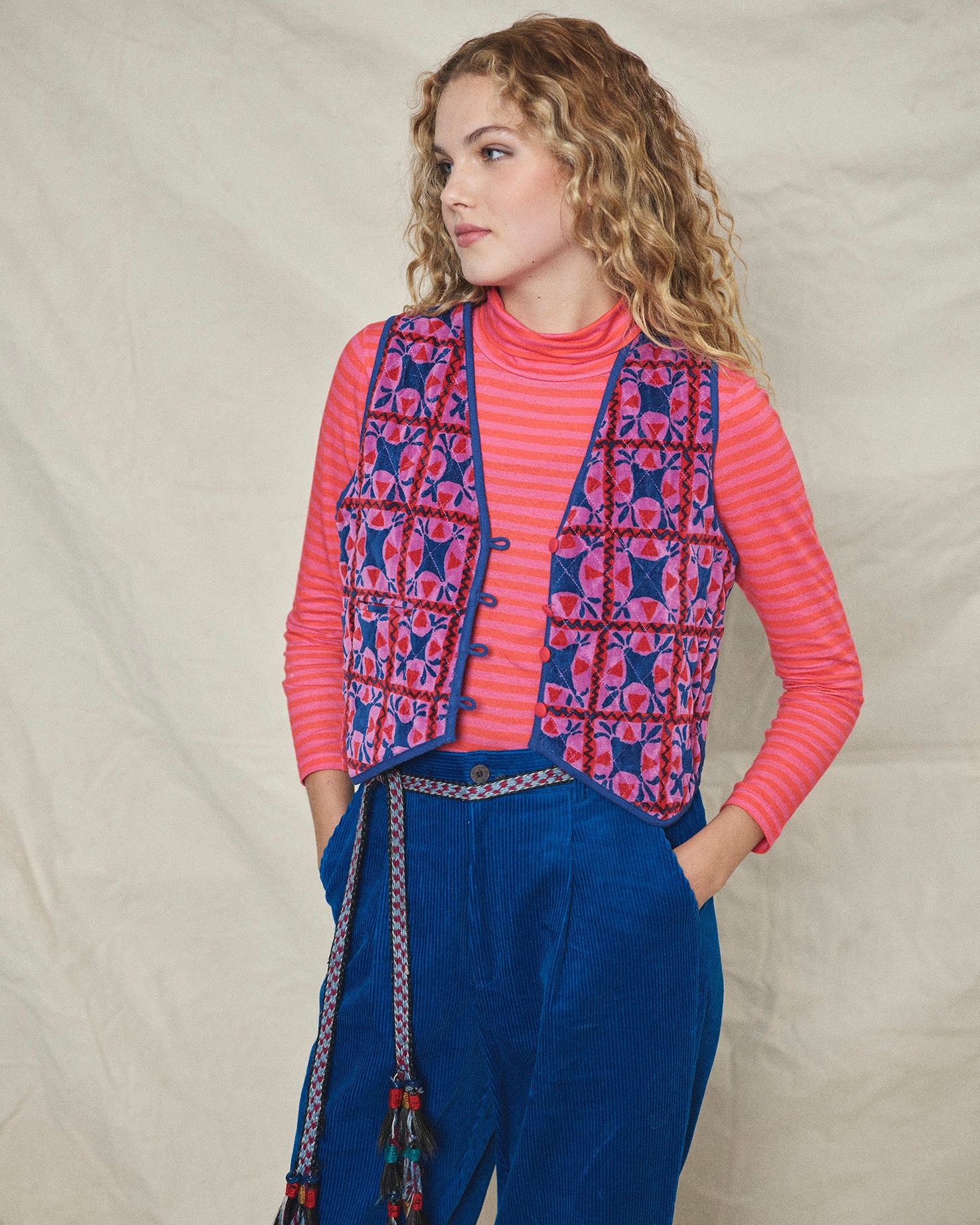 A long-sleeved pink striped organic cotton roll neck t-shirt.