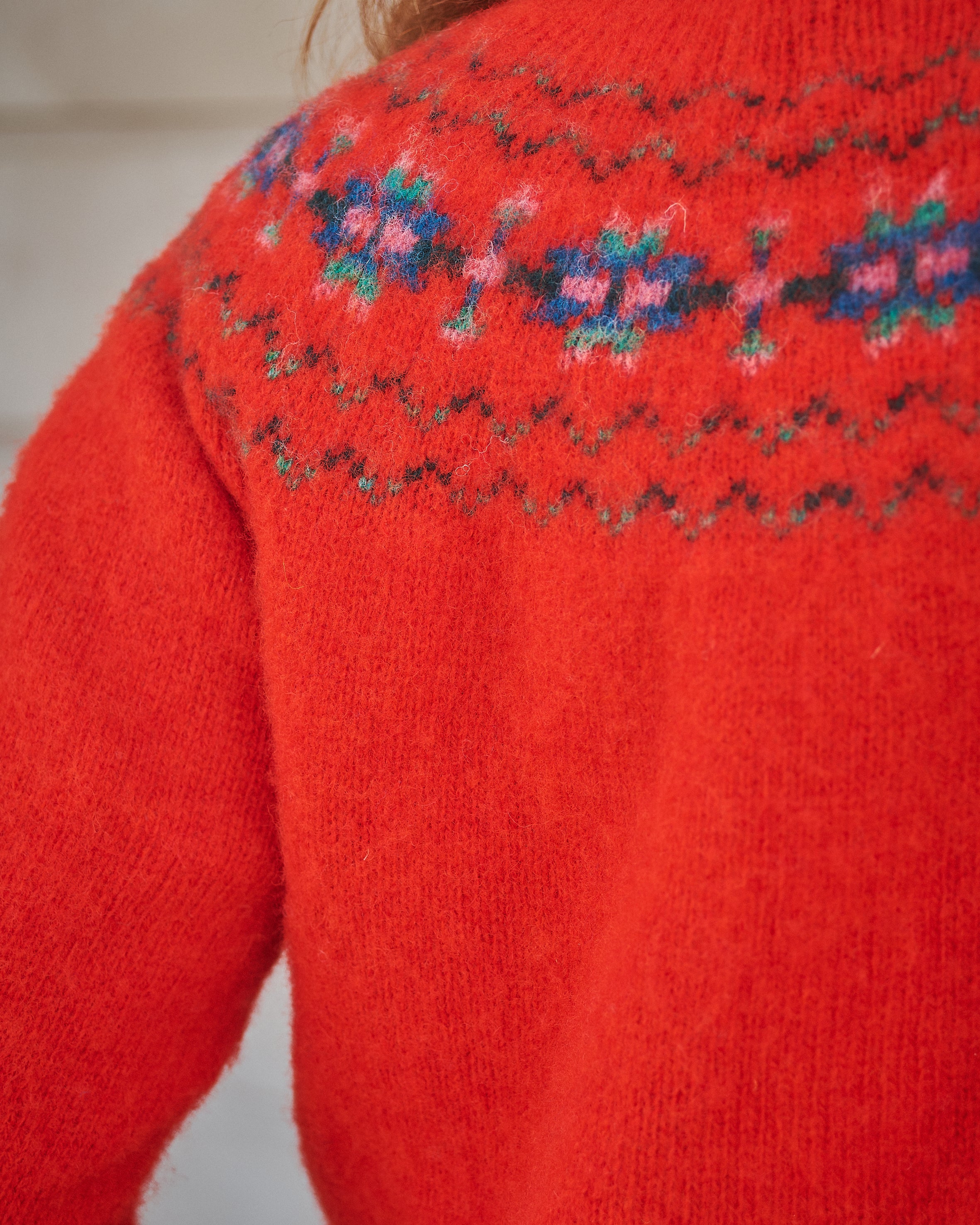 Red knitted sweater with floral pattern on the back