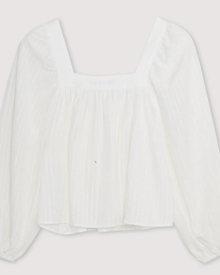 A white Tencel blouse with a square neckline, long sleeves, and elastic cuffs on a plain background.