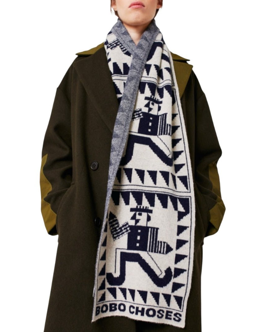 Person wearing a patterned scarf with 'BOBO CHoses' branding, standing against a white background.
