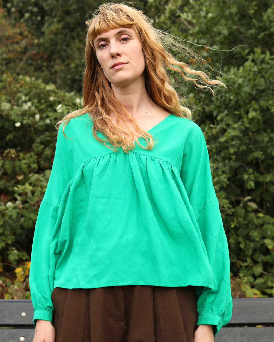 A vibrant grass green, voluminous statement top with a V-neckline and 3/4 length sleeves.