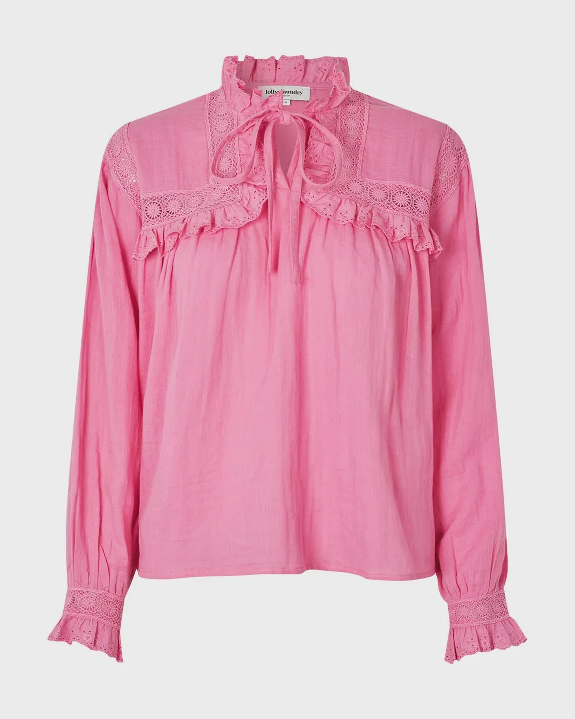 Pink blouse with lace details on a light gray background