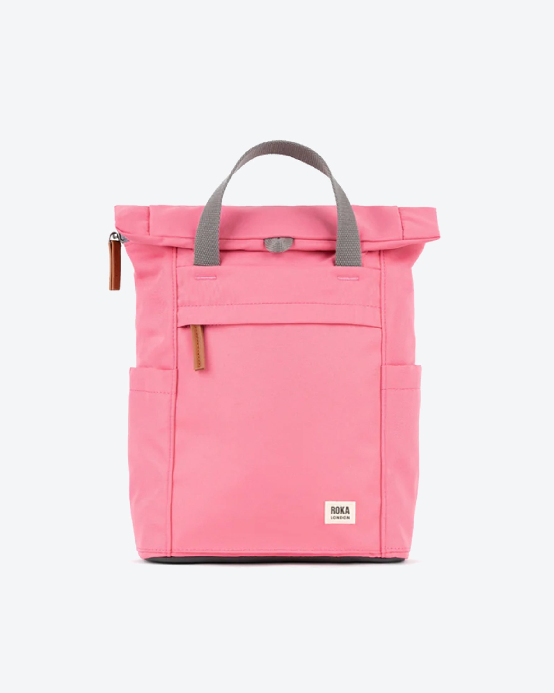 Pink backpack with gray handle on a white background