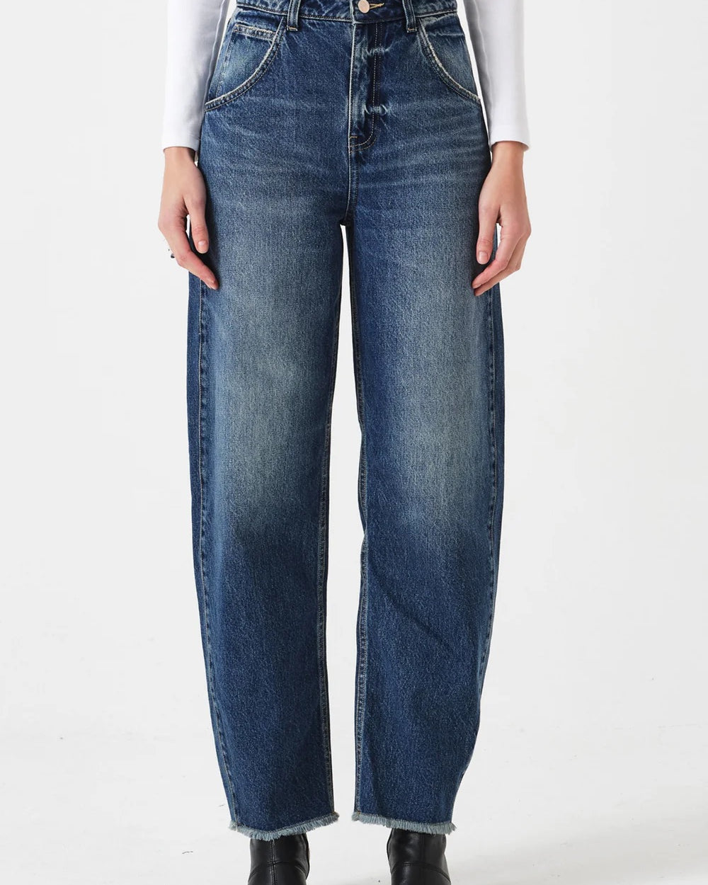 Person wearing blue jeans on a white background