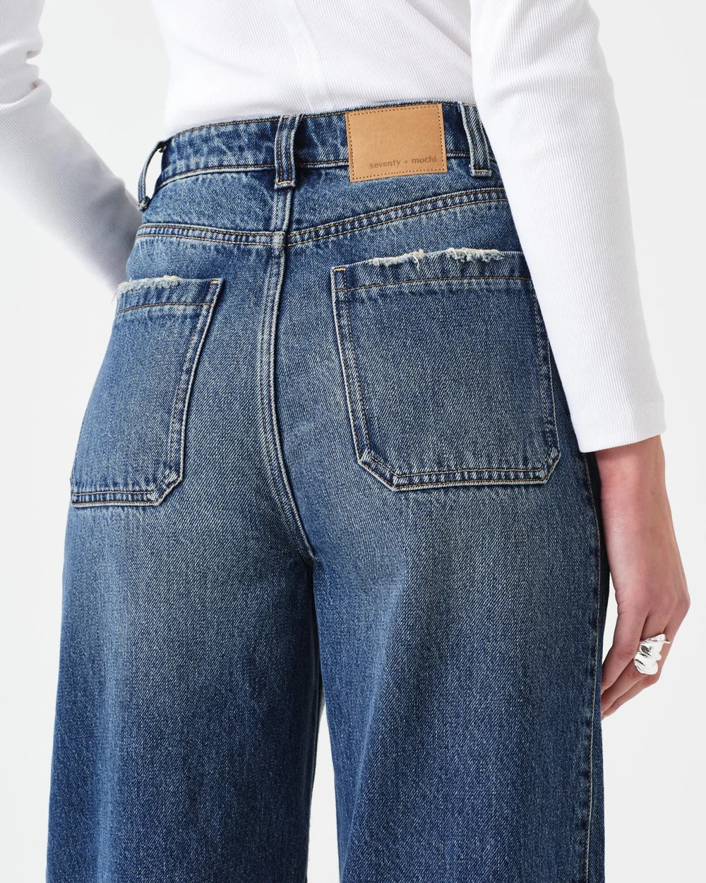Blue jeans with a white shirt on a white background