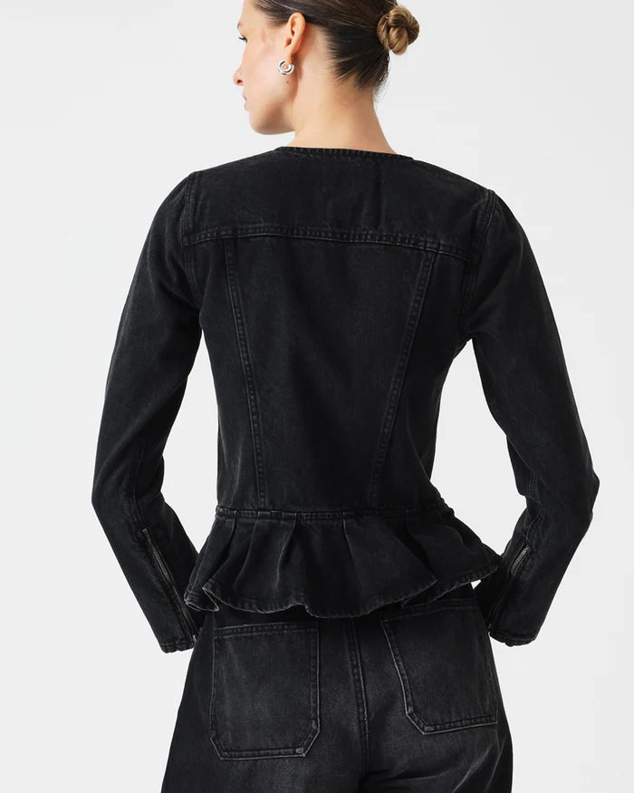 Person wearing a black denim jacket with peplum waist on a white background