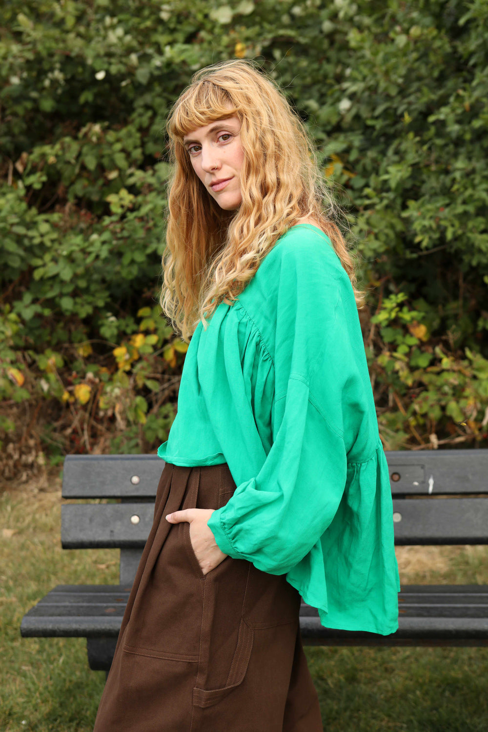 A vibrant grass green, voluminous statement top with a V-neckline and 3/4 length sleeves.
