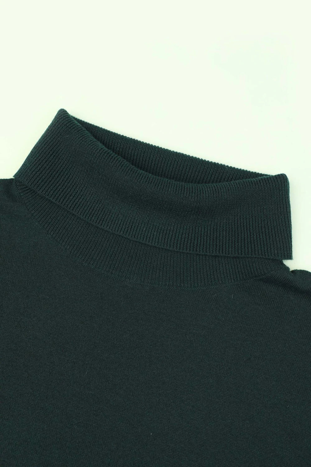 Close-up of a black turtleneck sweater collar on a white background