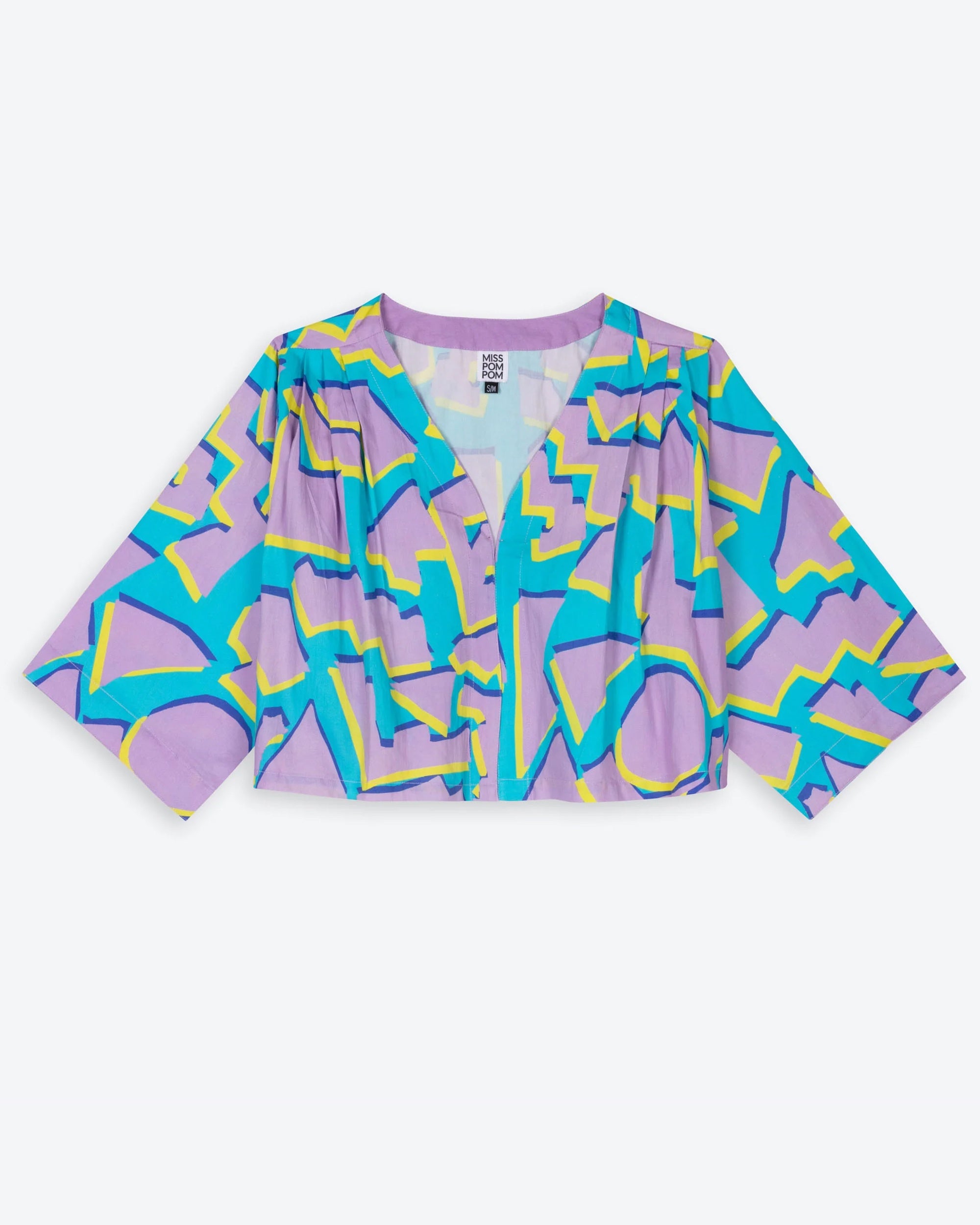 A cropped swing jacket with 3D geometric patterns in blue and purple colors, featuring wide sleeves and pleats from the shoulder.