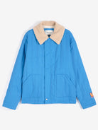A blue quilted jacket with a beige sherpa collar, featuring front patch pockets and a small orange label on the left sleeve, displayed against a clean white background.