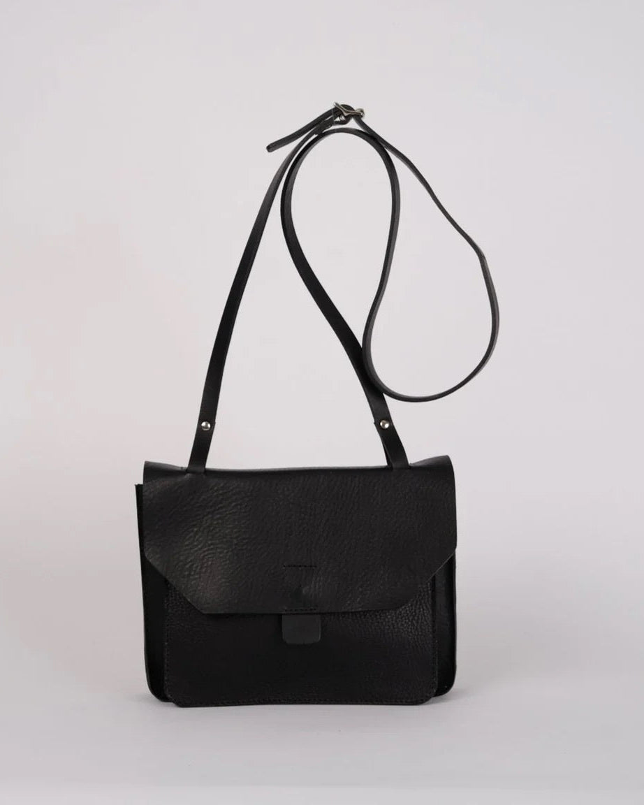 Black leather shoulder bag on a light gray background