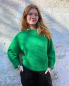 Person Wearing a bright green mohair jumper 