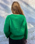Person Wearing a bright green mohair jumper 