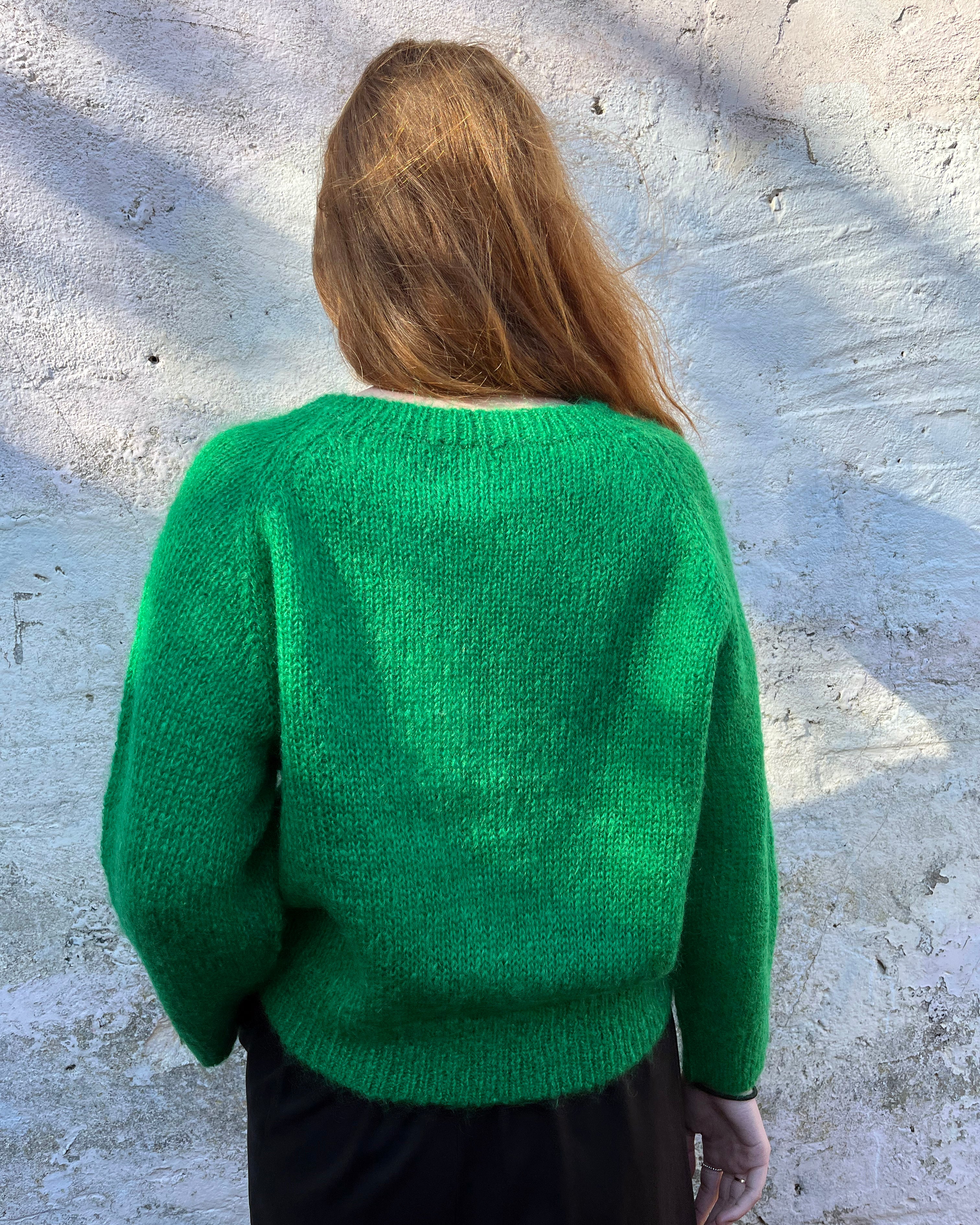 Person Wearing a bright green mohair jumper 