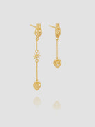 Gold heart-shaped earrings on a light gray background