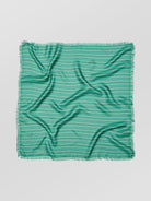 Green striped fabric on a light gray background