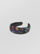 Decorative headband with colorful floral pattern on a light gray background