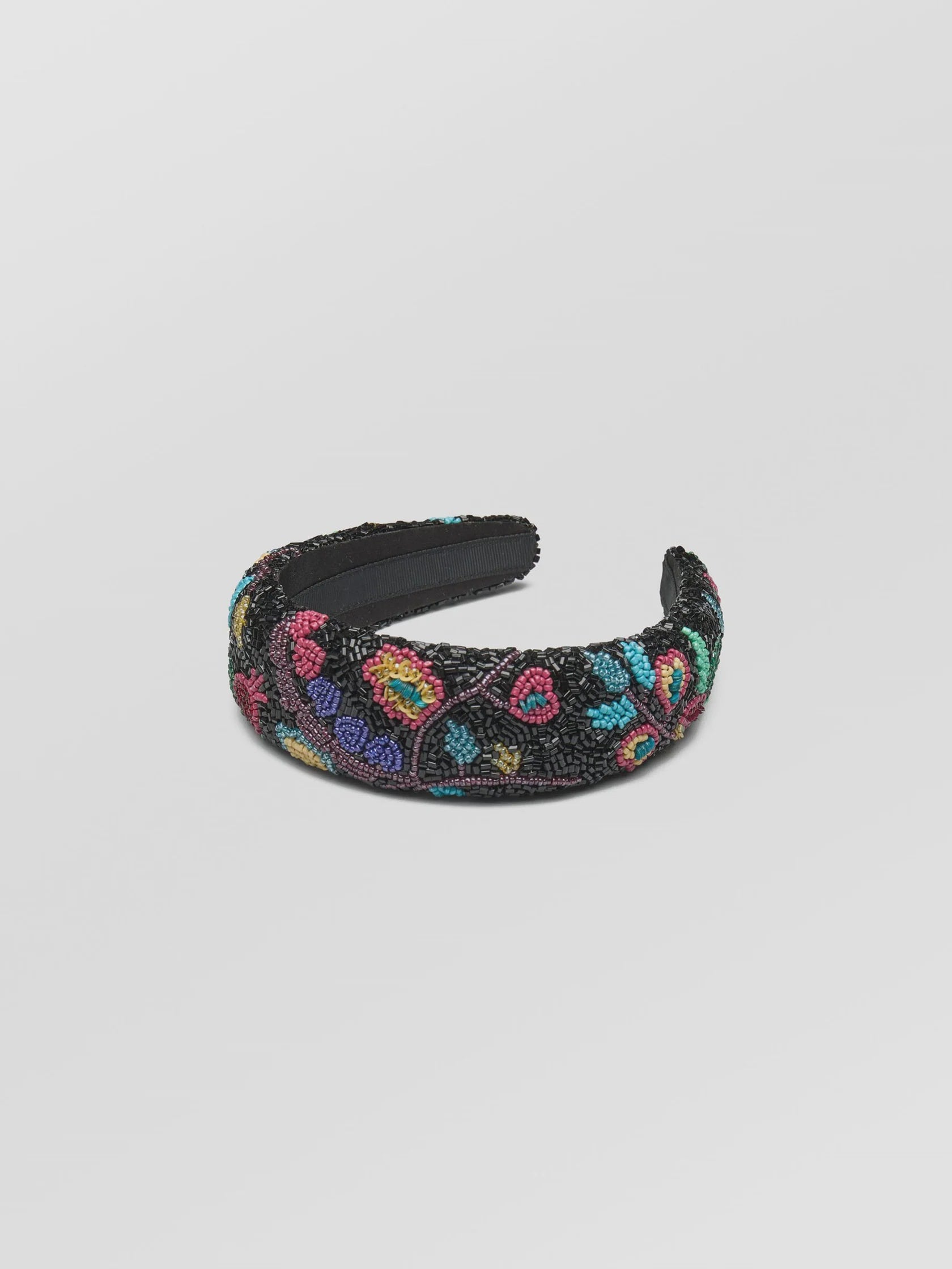 Decorative headband with colorful floral pattern on a light gray background