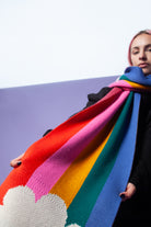 Person wearing a rainbow scarf