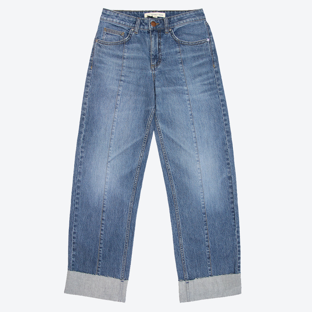 A pair of blue denim jeans with a deep frayed turn up at the hem, featuring a straight leg cut and mid-rise waist.
