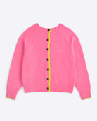 Pink cardigan with black buttons on a light purple background