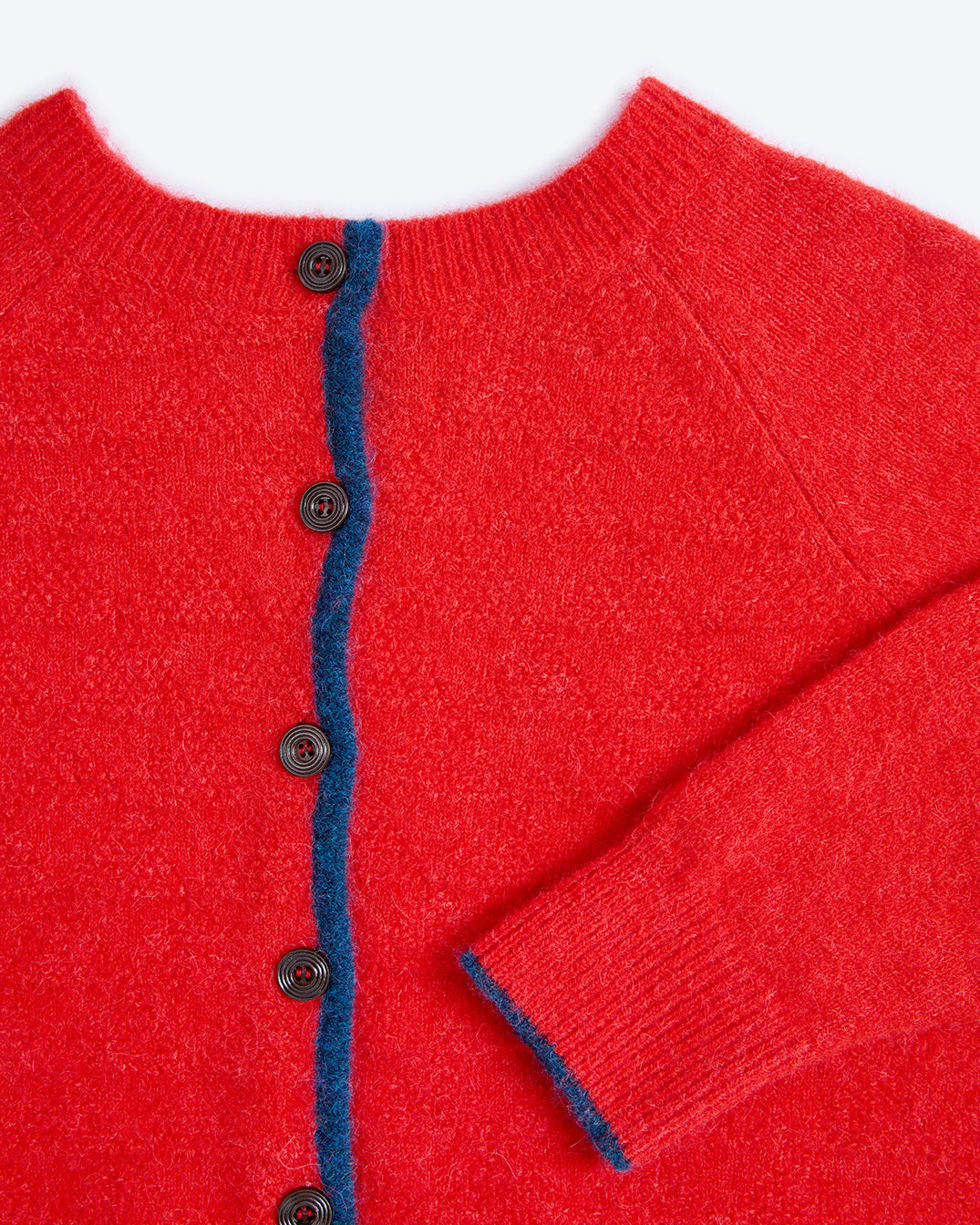 Red cardigan with blue trim and buttons on a white background