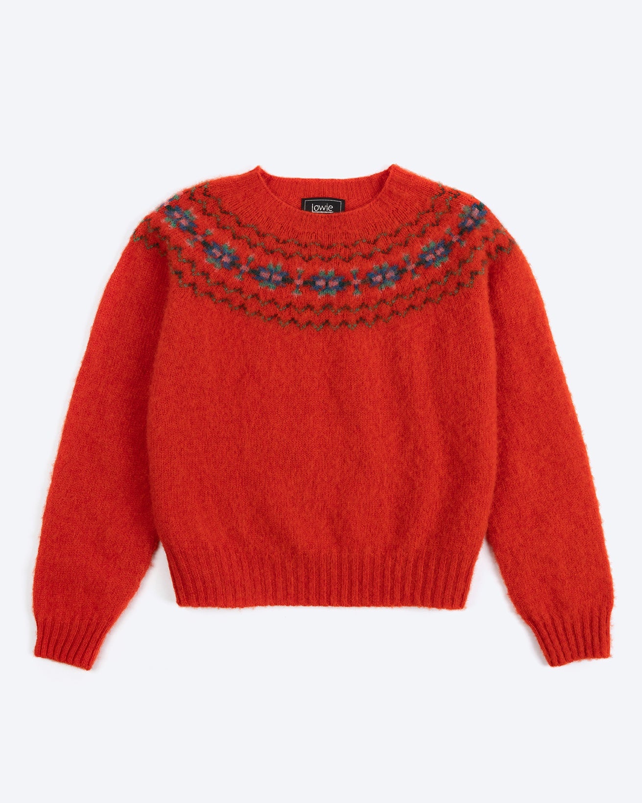 Red sweater with patterned neckline on a white background
