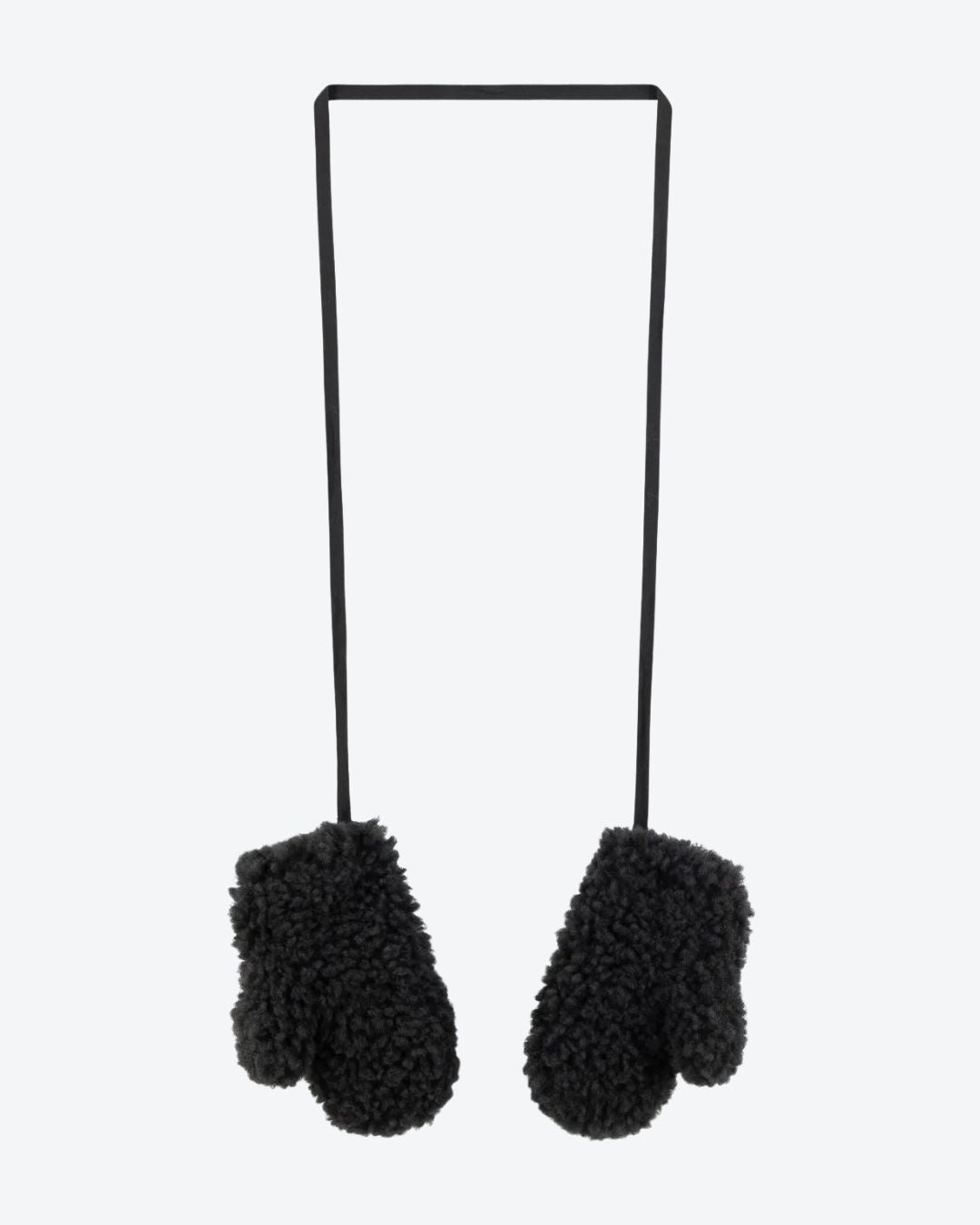 Black fuzzy mittens on a black stand against a white background