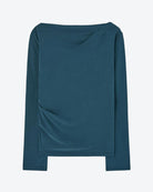 Teal long-sleeve top on a light gray background