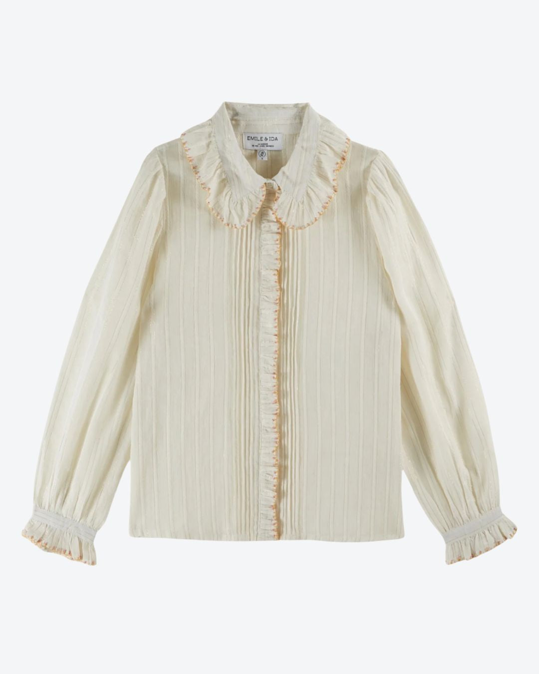 Cream-colored blouse with ruffled collar and cuffs on a white background