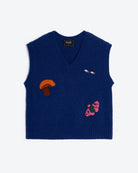 A navy blue knit sweater vest with a V-neck, featuring embroidered motifs of an orange-brown mushroom, a small pink-and-white bird, and a pink-and-black butterfly on the front, displayed against a light gray background.